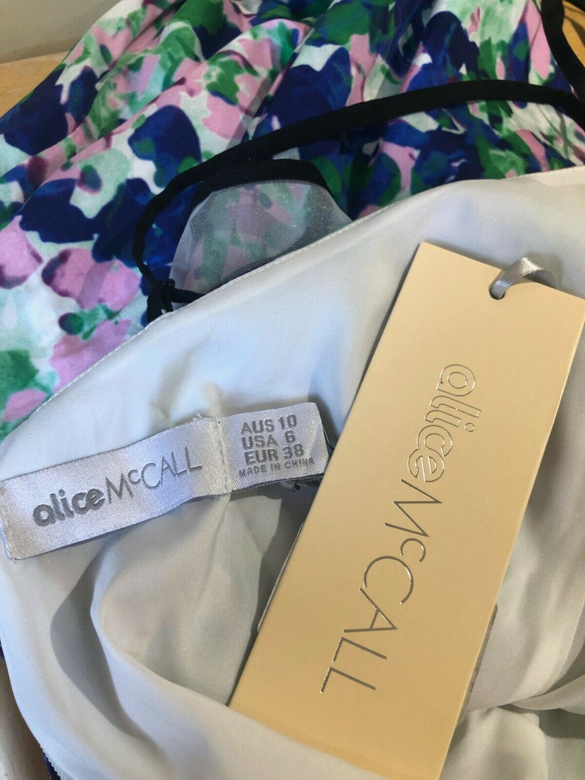 Dress with floral pattern and 'alice mccall' branding on a white background