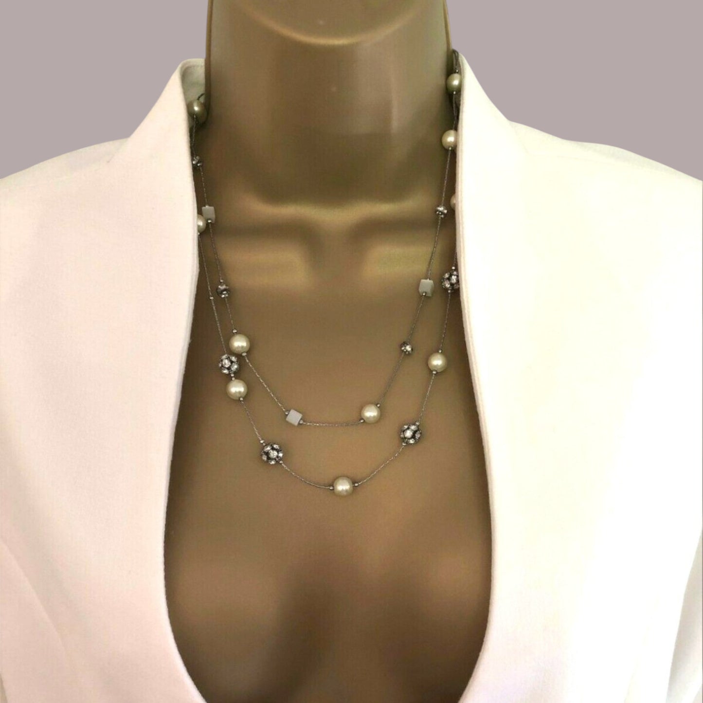 Close up of white cropped jacket on a gray background