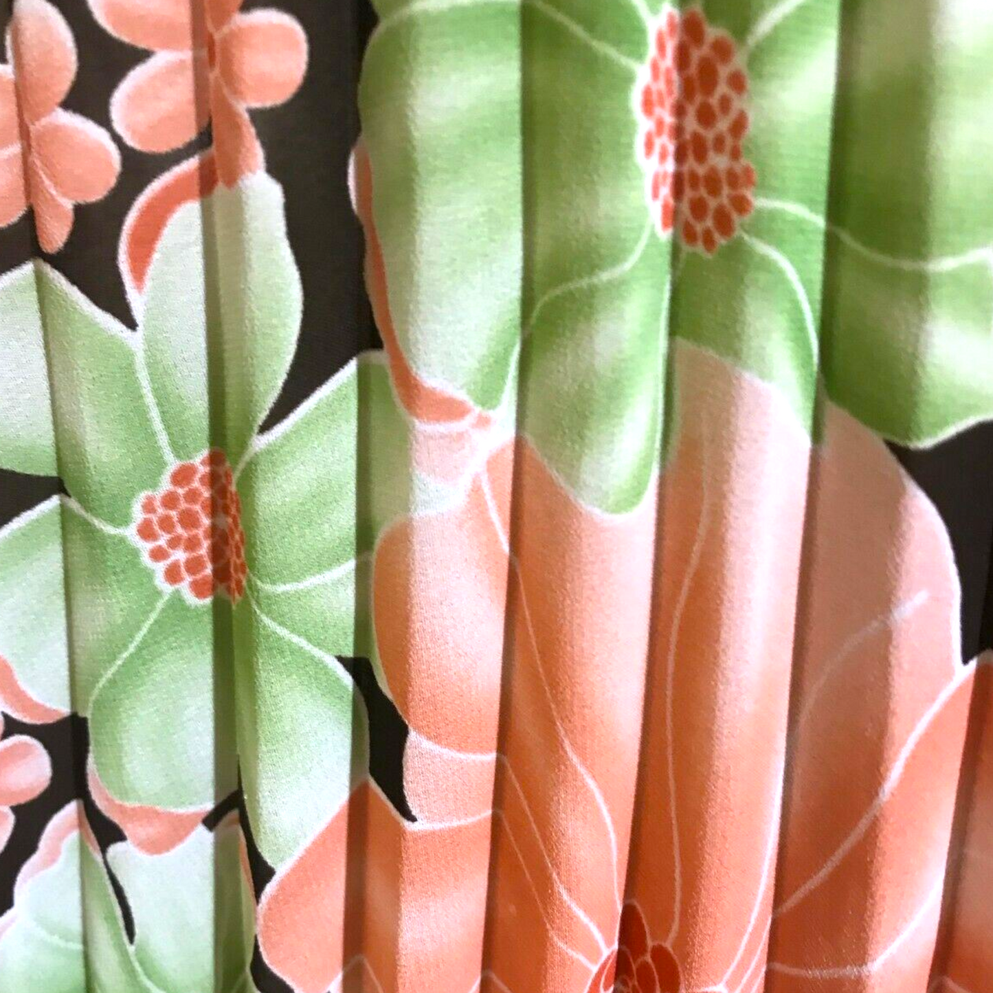 Floral pleat detail on floral top on beige background