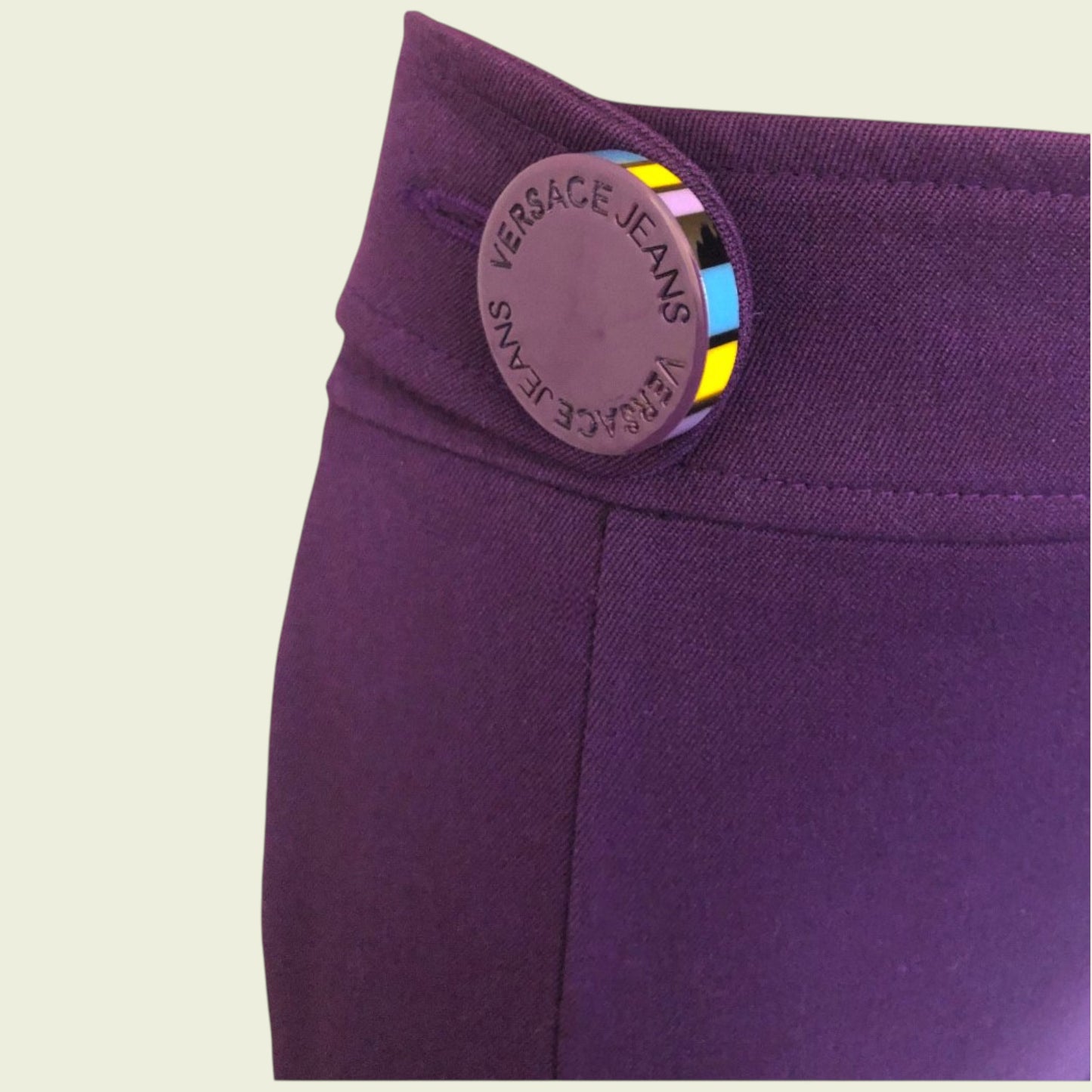 Purple garment with Versace Jeans label on a beige background