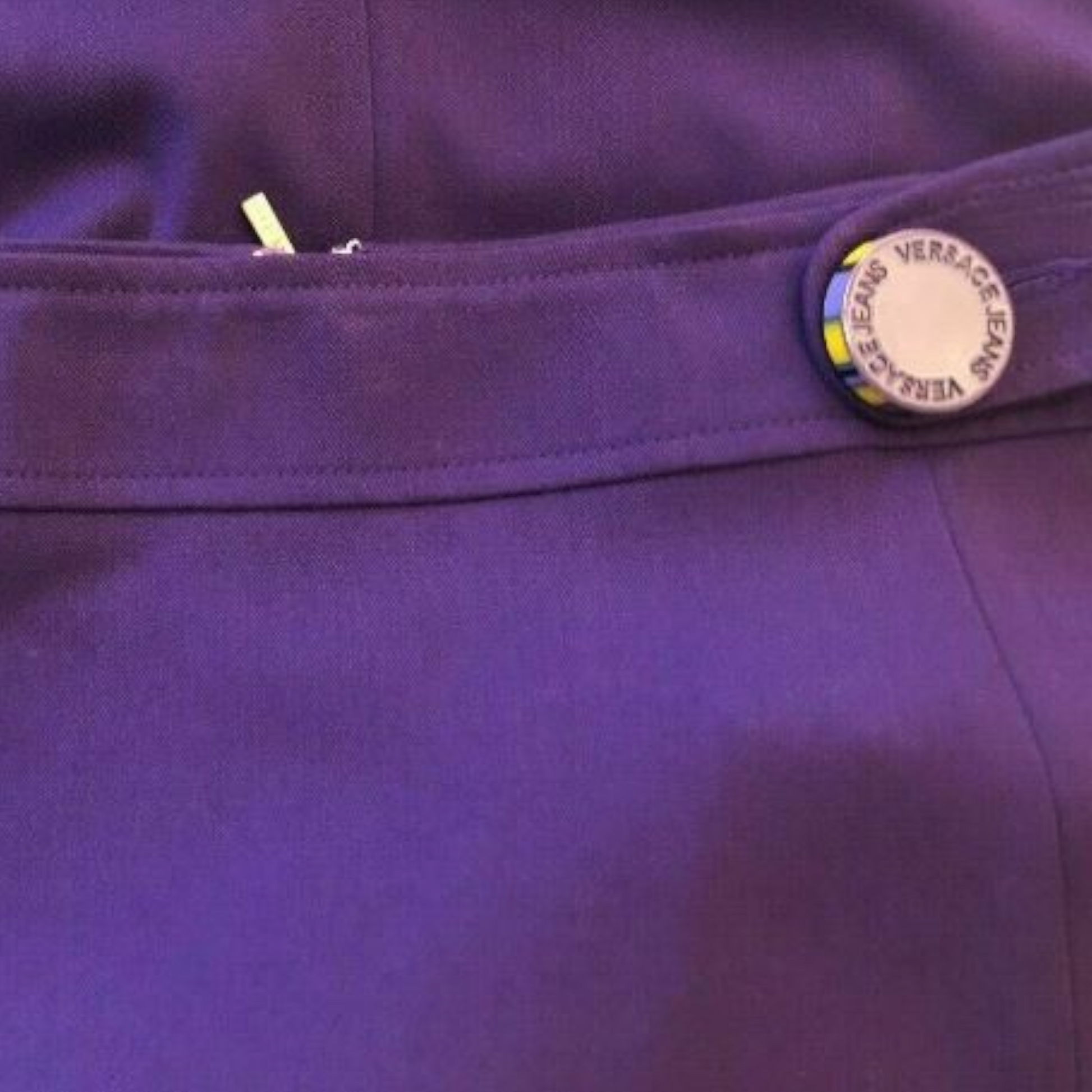 Close-up of a purple garment with Versace label