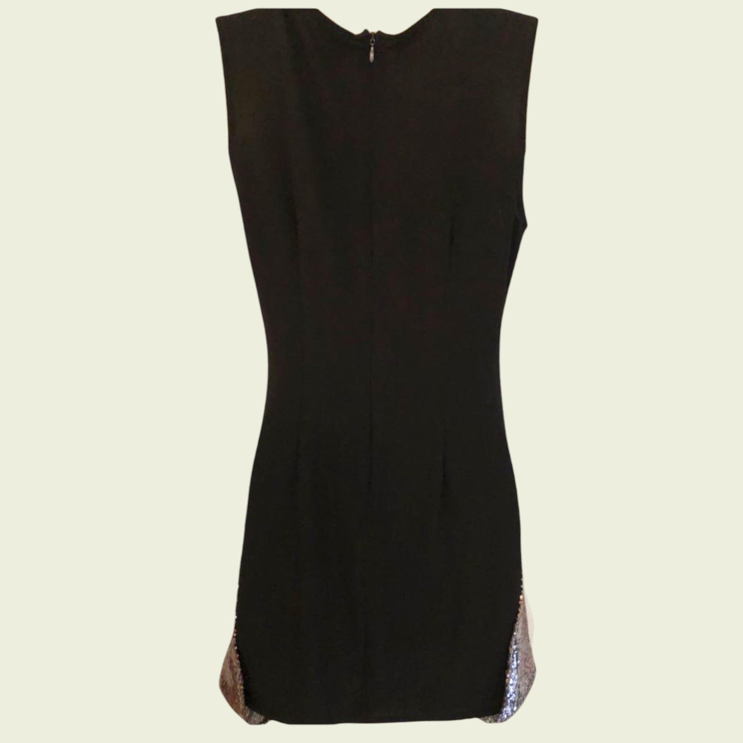 Black sleeveless dress with a subtle pattern on a beige background