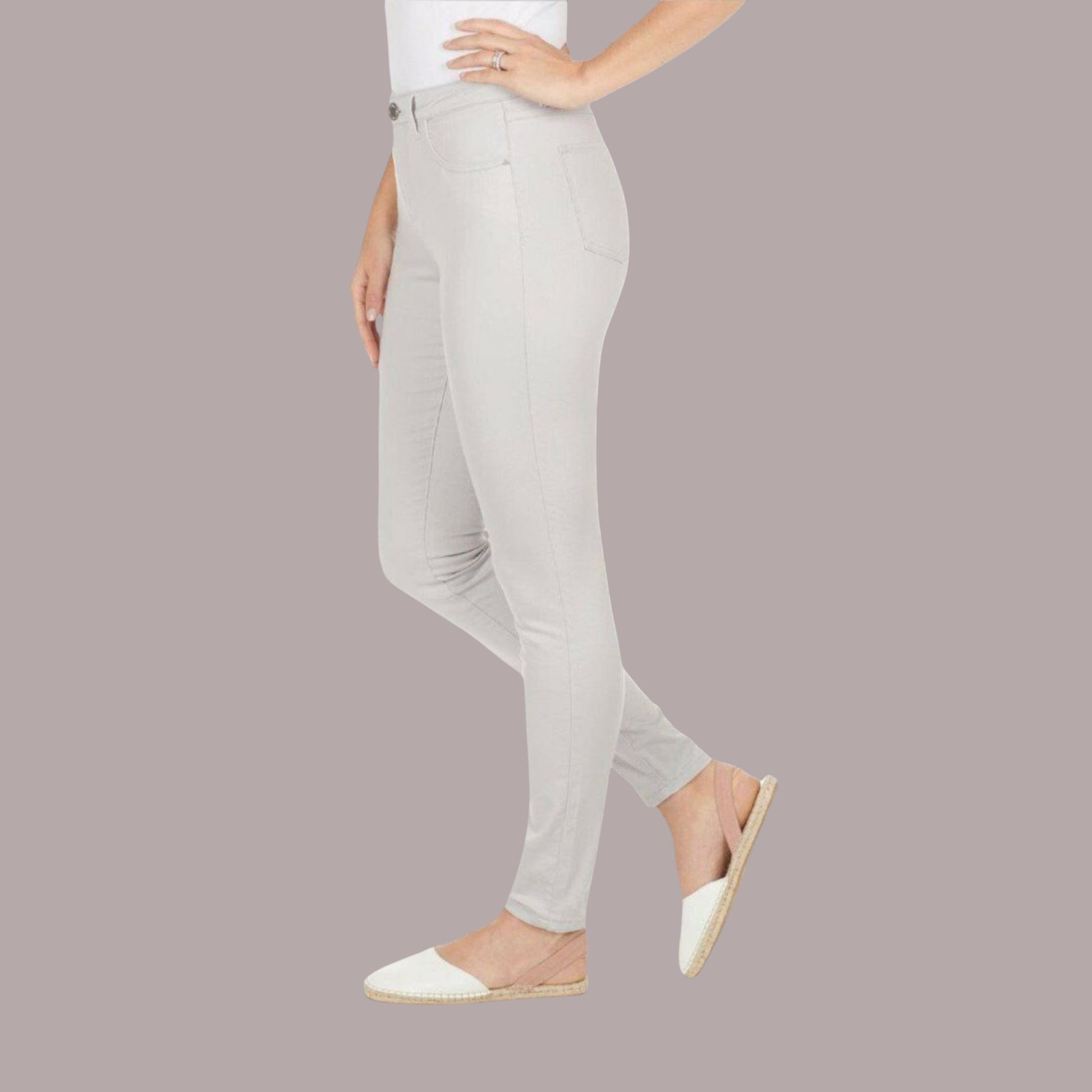 Light gray pants worn by a person on a plain background