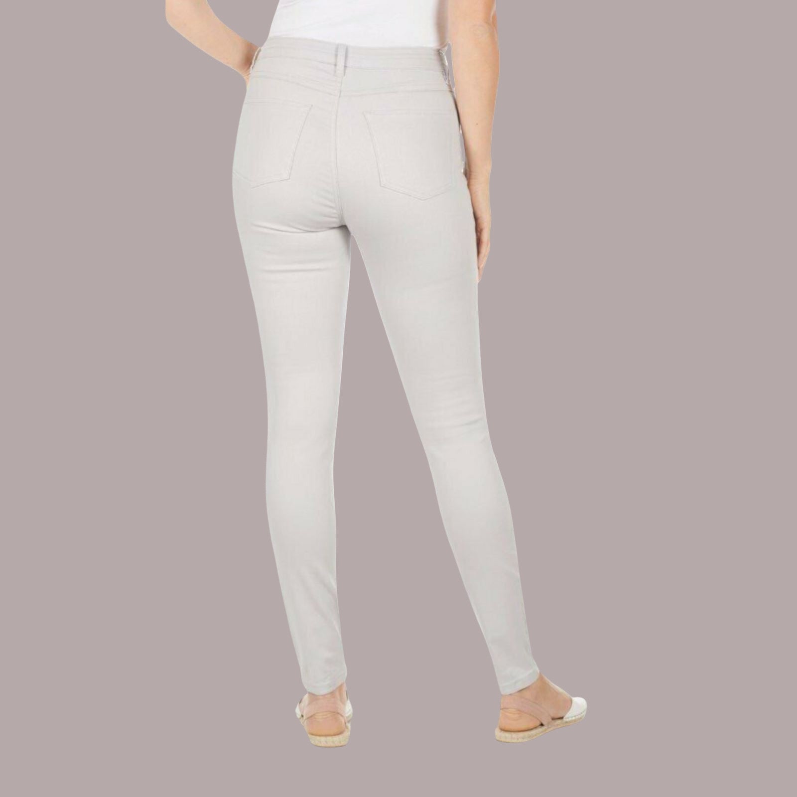 Light gray pants worn by a person on a plain background