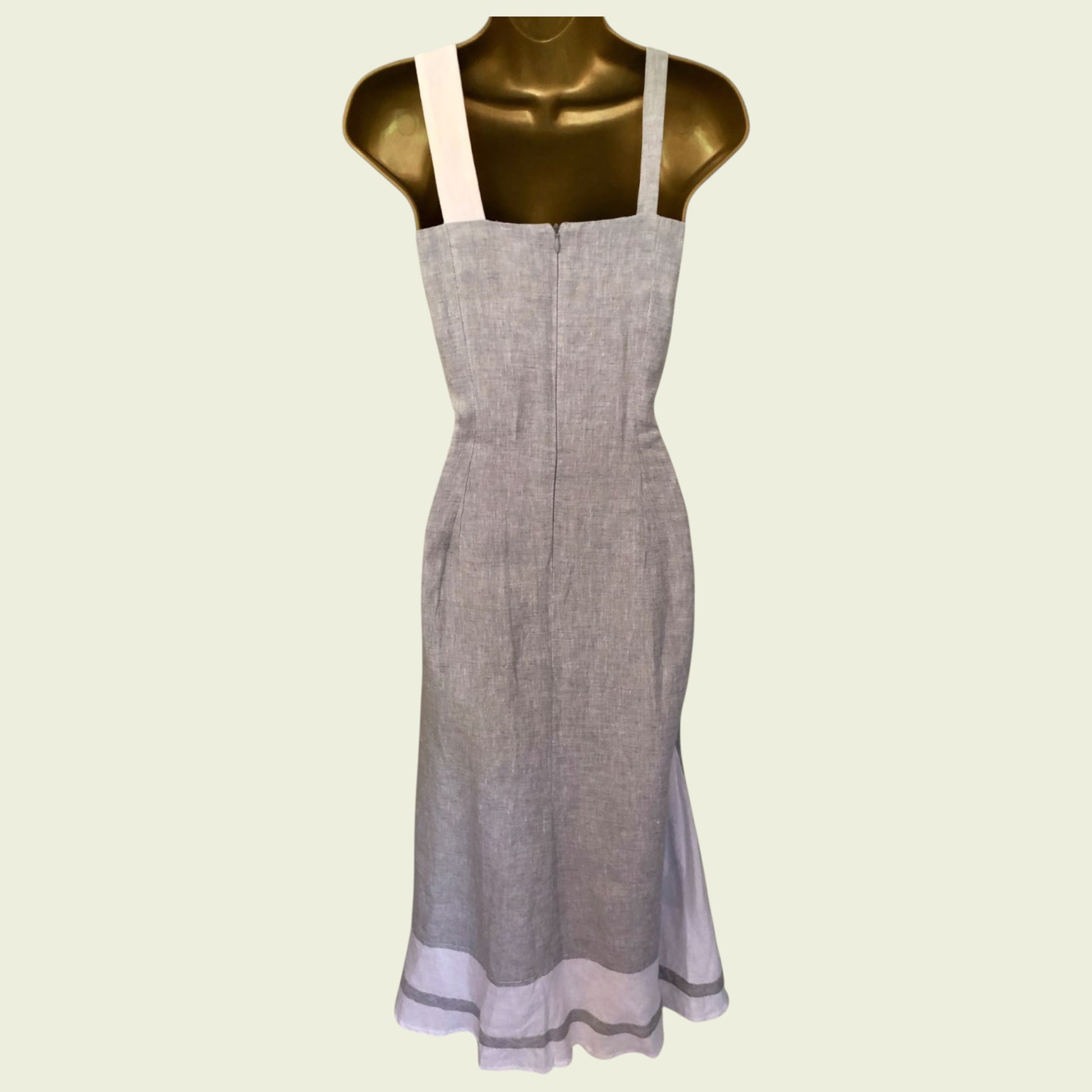 Gray apron on a mannequin against a light green background