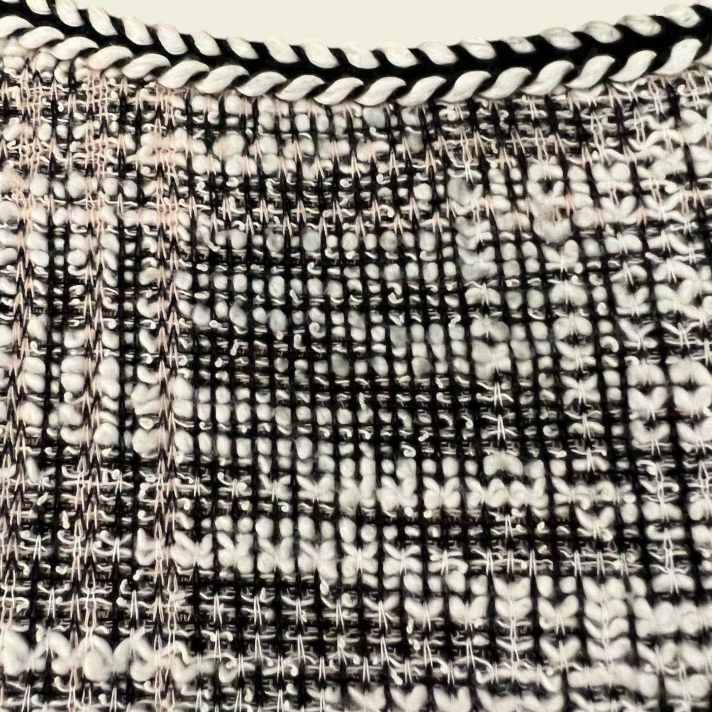 Close-up of a woven black and white patterned fabric.