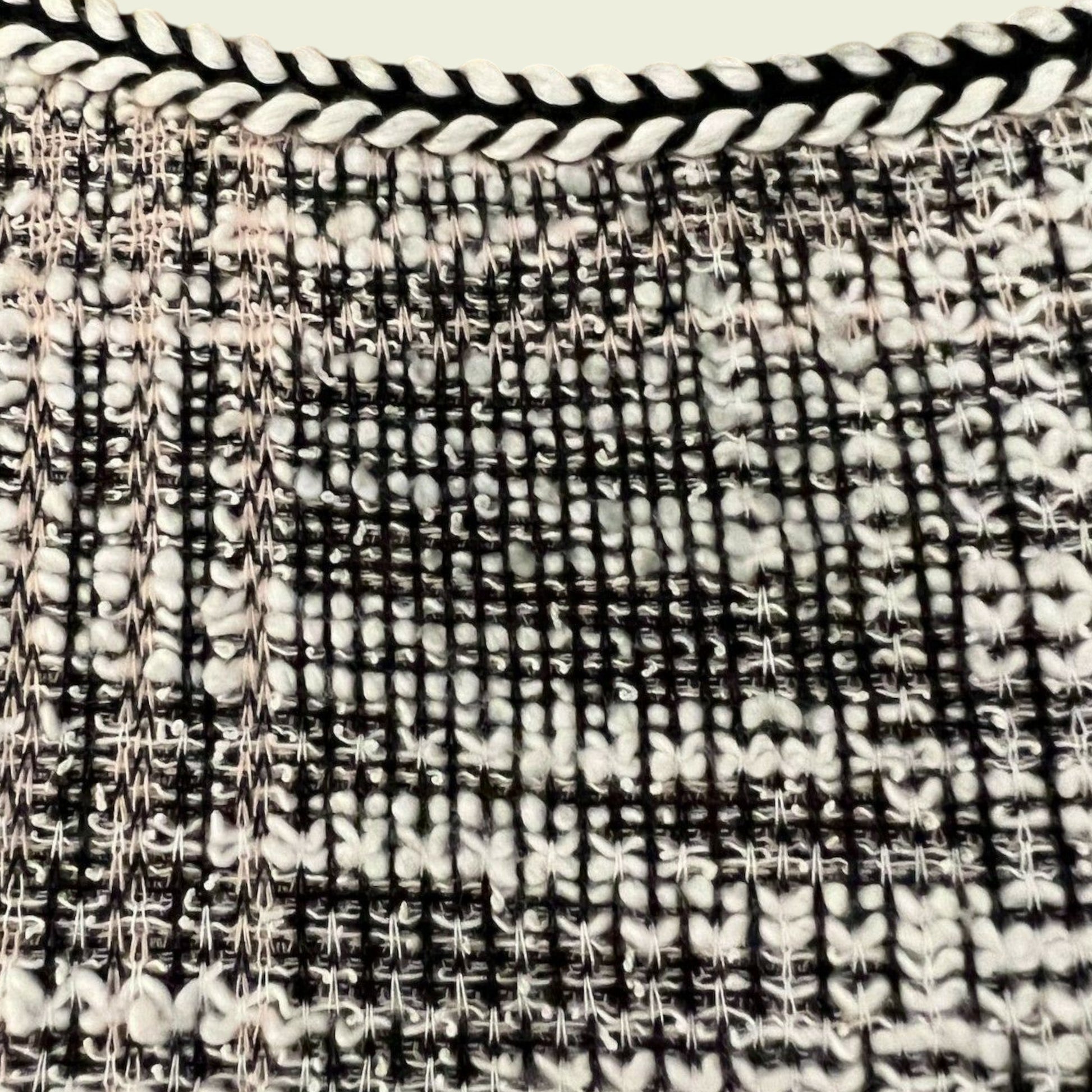 Close-up of a woven black and white patterned fabric.