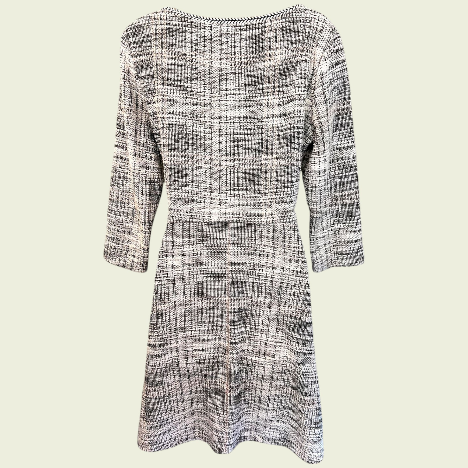 Black and white checkered dress with three-quarter sleeves on a light beige background