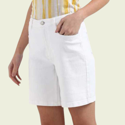 Model wearing white shorts on a beige background