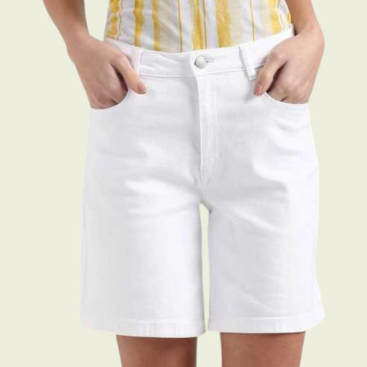 Model wearing white shorts on a beige background