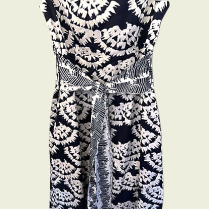 Navy blue dress with white floral pattern on a plain background
