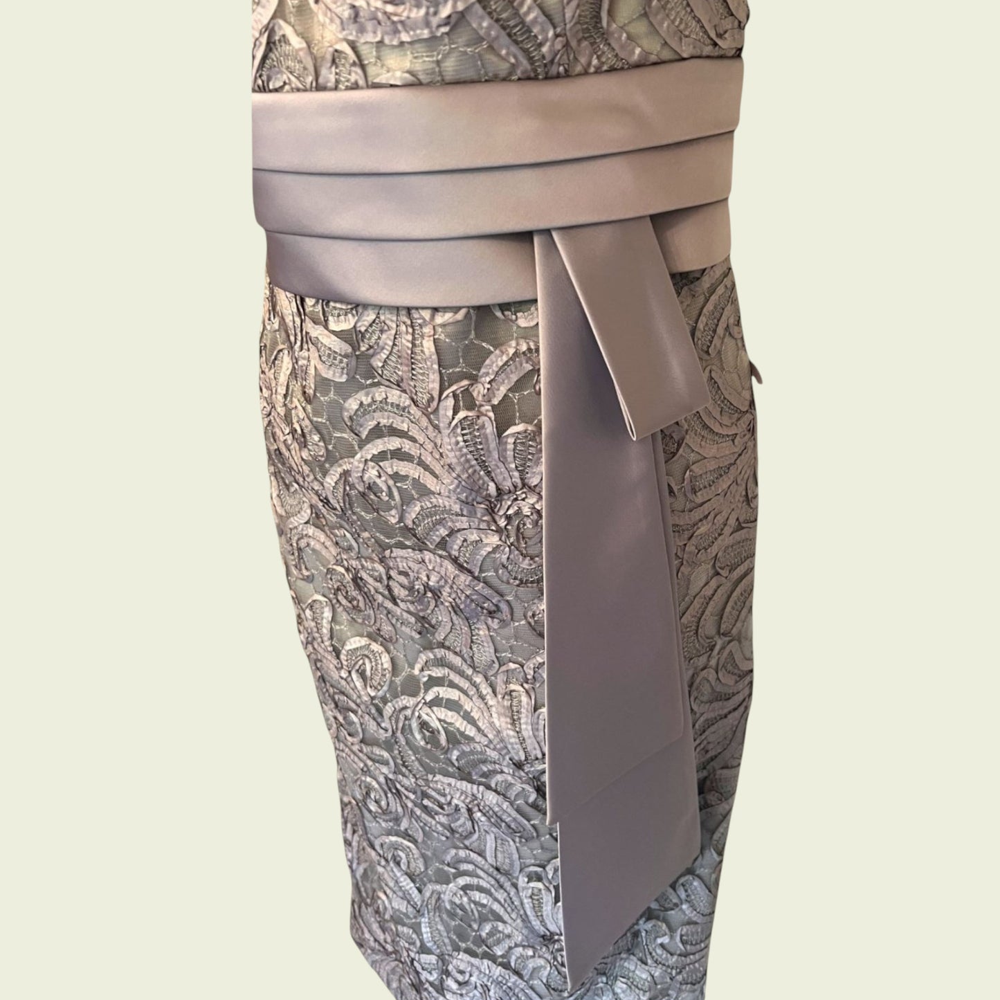 Patterned dress with a belt on a light beige background