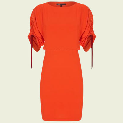 Red dress with ruched sleeves on a beige background