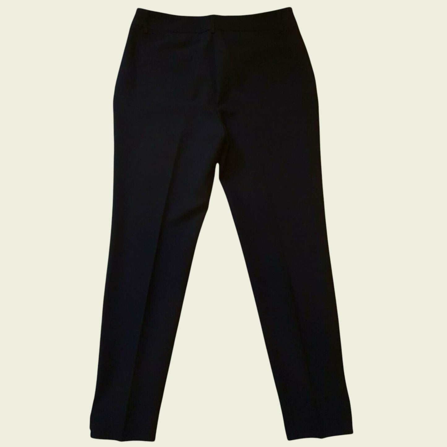 Black pants on a beige background