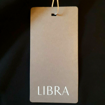 Clothing tag with 'LIBRA' text on a dark background