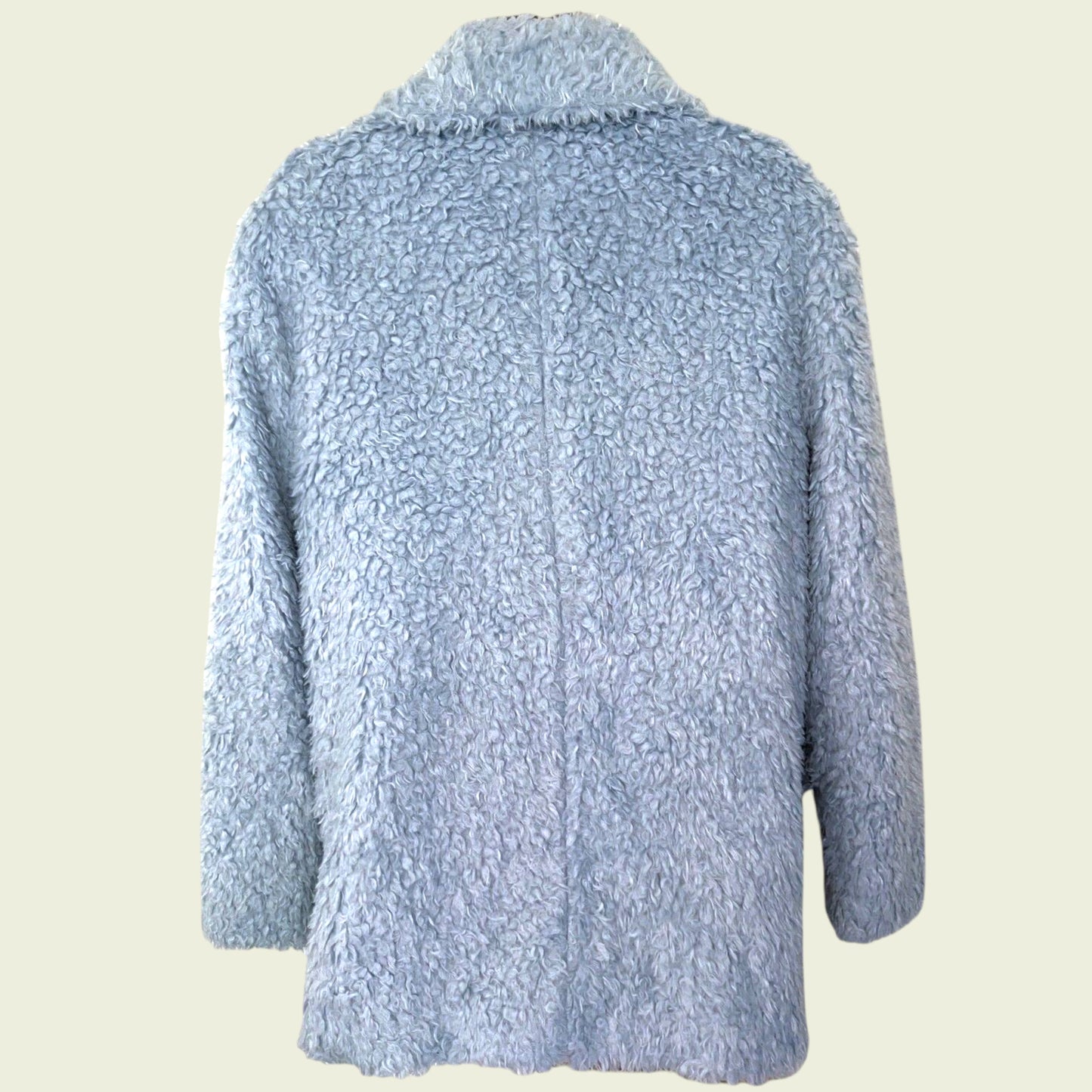 Light blue textured jacket on a beige background