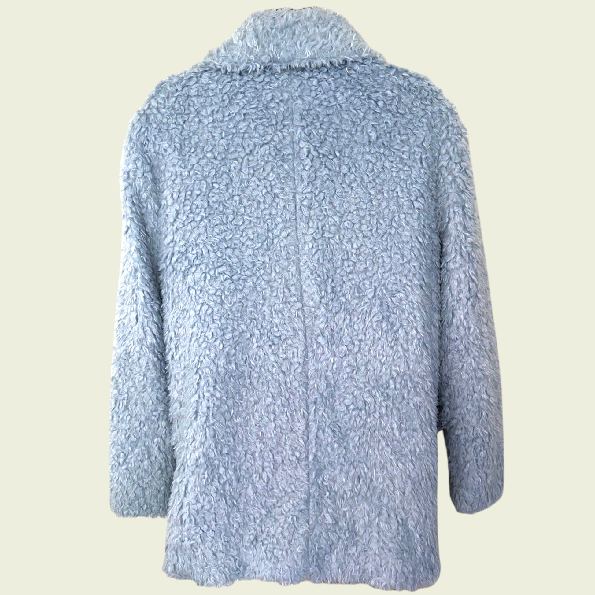 Light blue textured jacket on a beige background