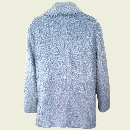 Light blue textured jacket on a beige background