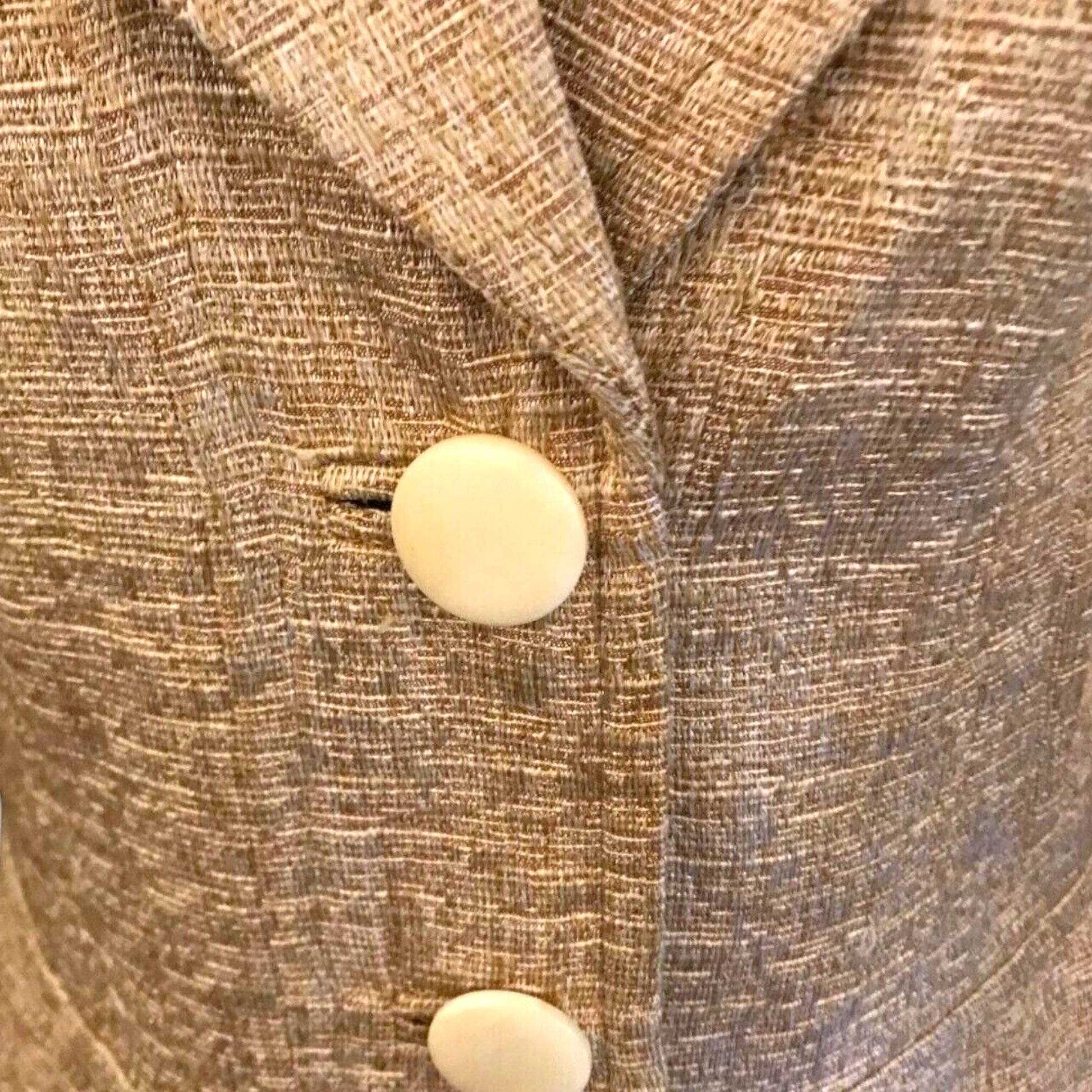 Close-up of a textured fabric with a button on a garment