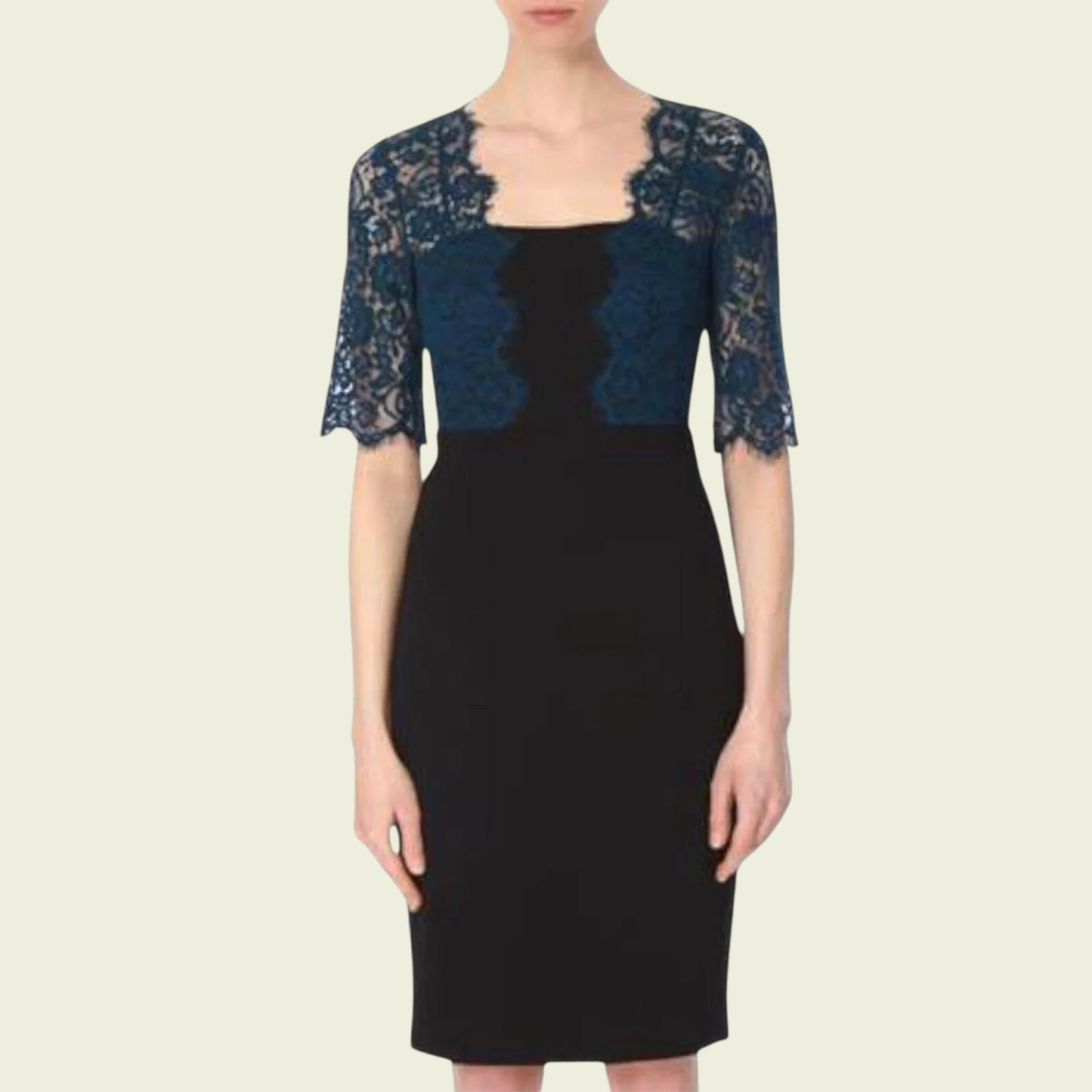 Model wearing black dress with teal lace bolero on beige background
