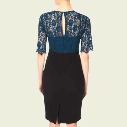 Model wearing black dress with teal lace bolero on beige background