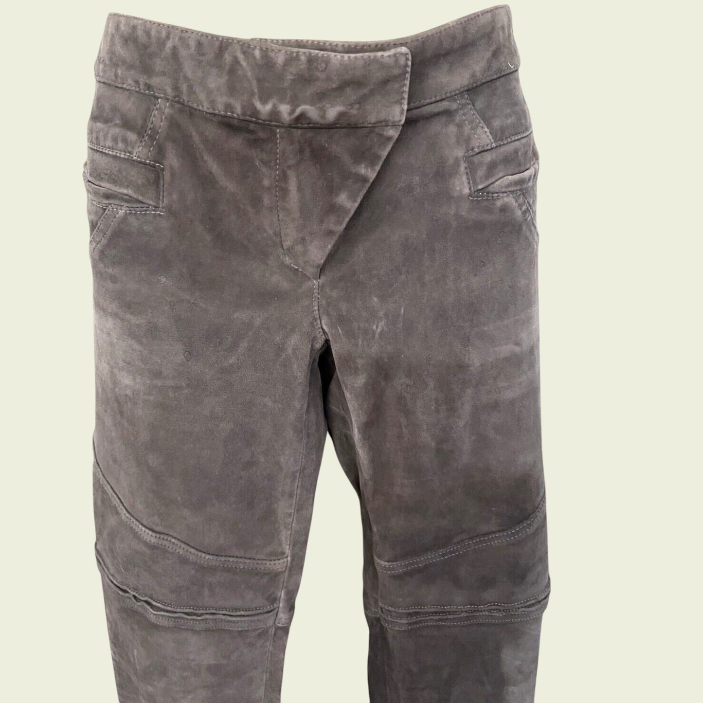Grey suede pants on a beige background 