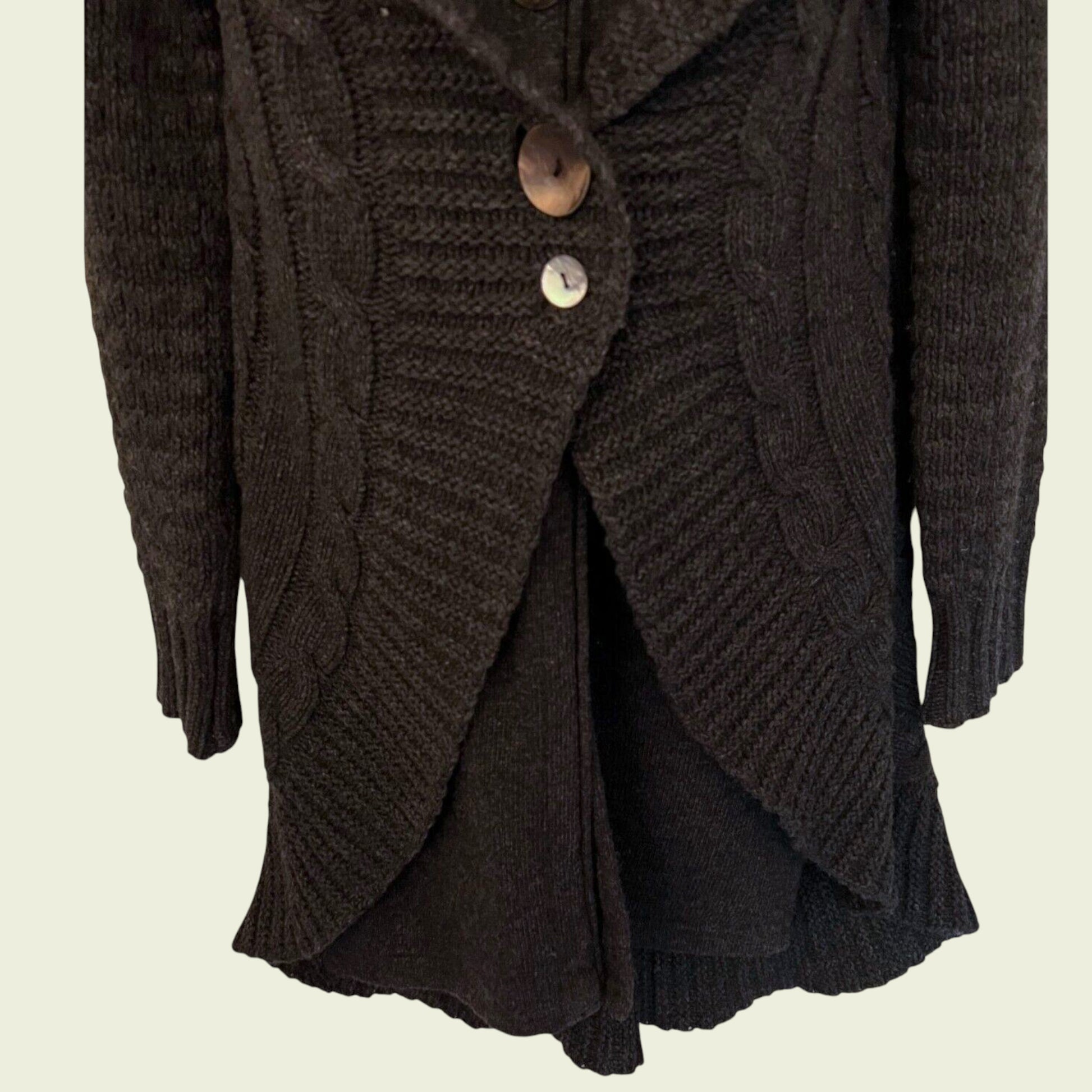 Dark brown knitted cardigan with buttons on a beige background