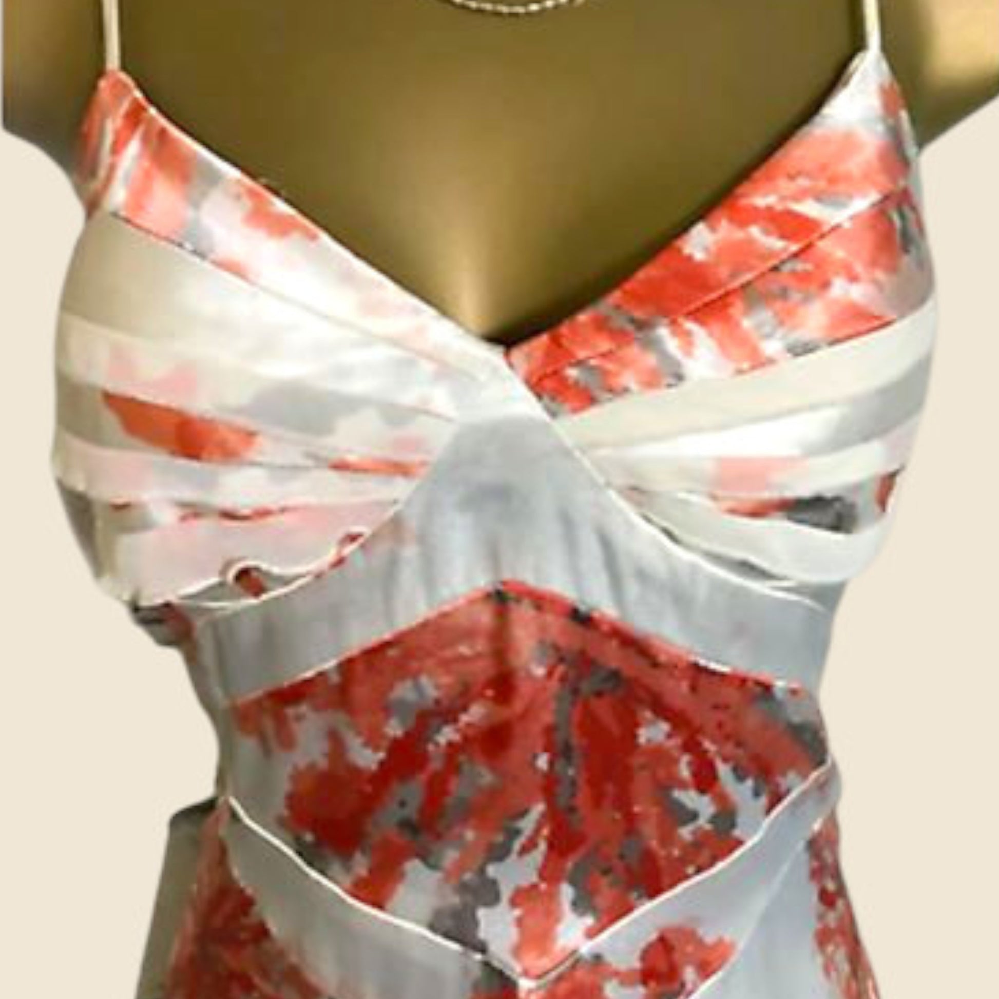 Floral patterned dress on a mannequin against a beige background