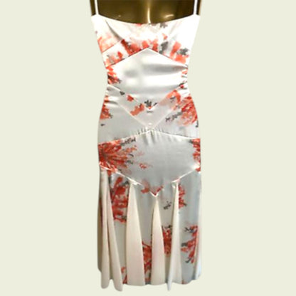 White dress with red floral pattern on a mannequin against a white background