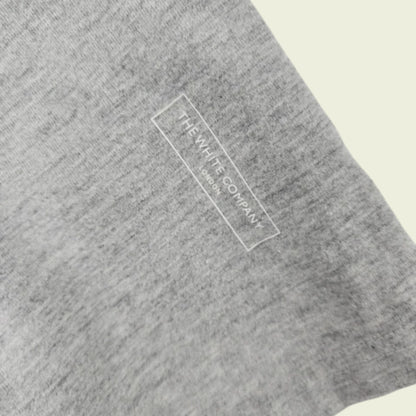 Gray fabric with 'The White Company' logo on a beige background