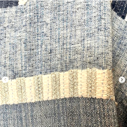 Close-up of textured fabric with a beige stripe