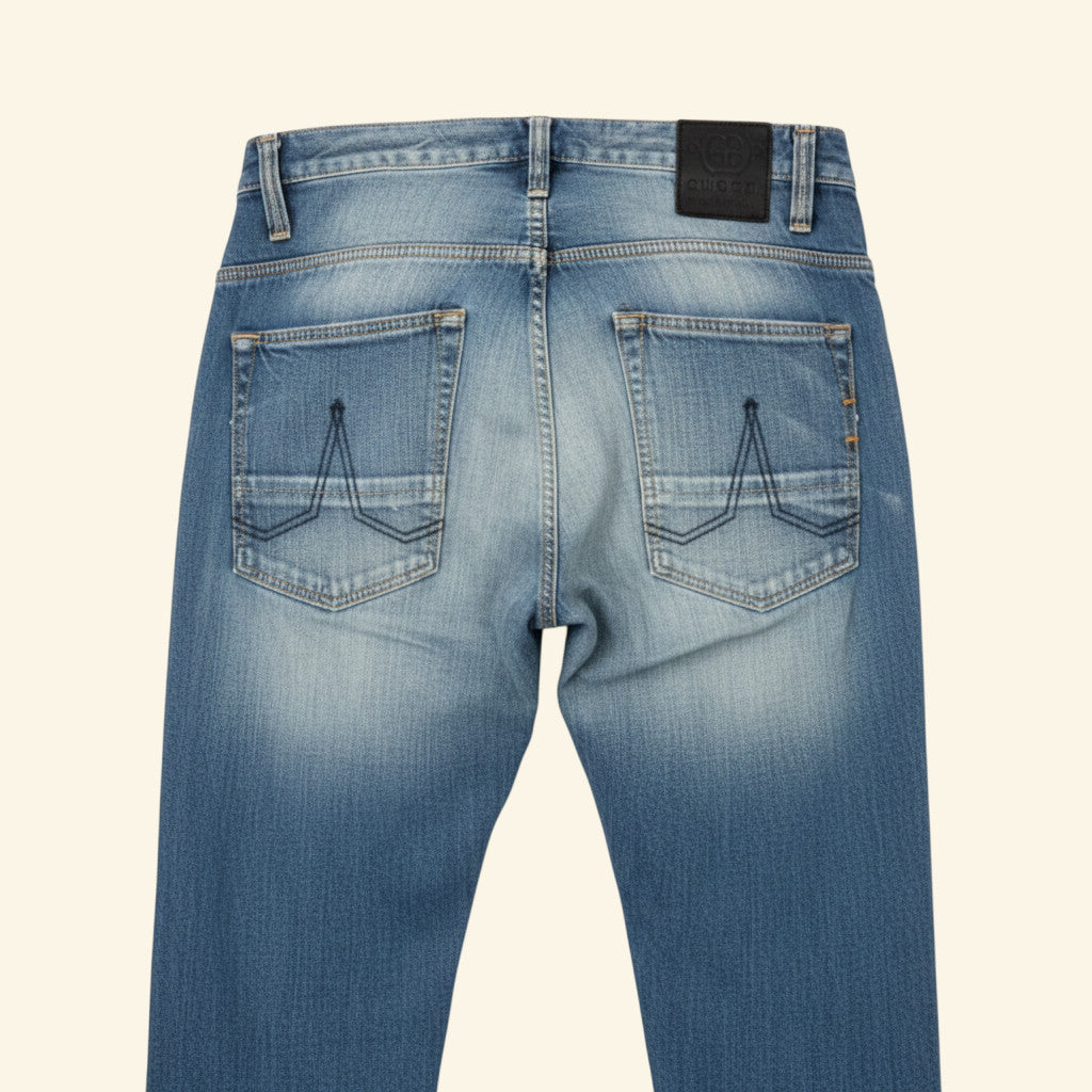 Light blue denim jeans with a faded wash, laid flat against a light off-white background.