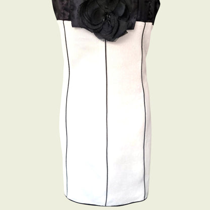 Black and white dress with a floral detail on a beige background