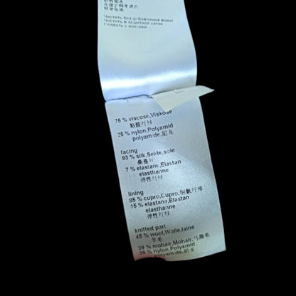 Textile label with material composition details on a black background