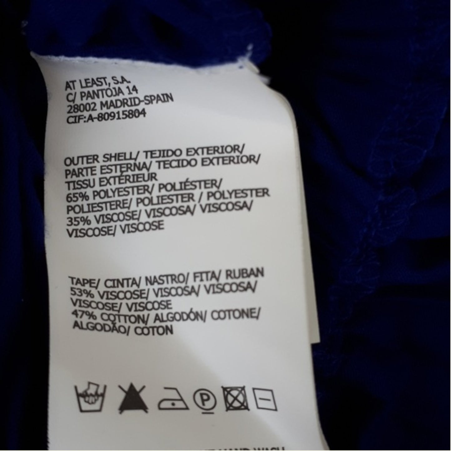 Clothing label with text and symbols on a dark background