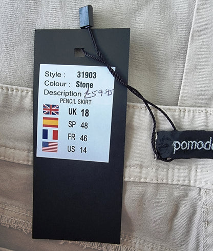 Clothing tag with size and style information on a beige fabric background