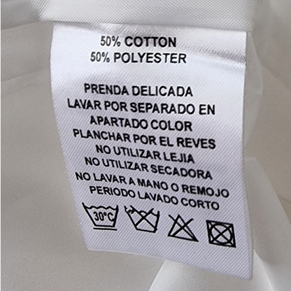 Clothing label with care instructions on a white fabric background