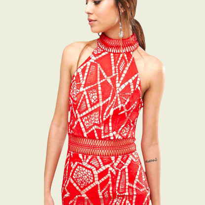 Woman wearing a red and white patterned dress on a beige background