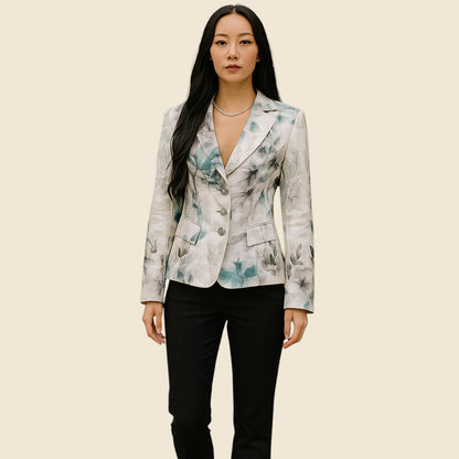 Woman wearing a floral blazer and black pants on a beige background