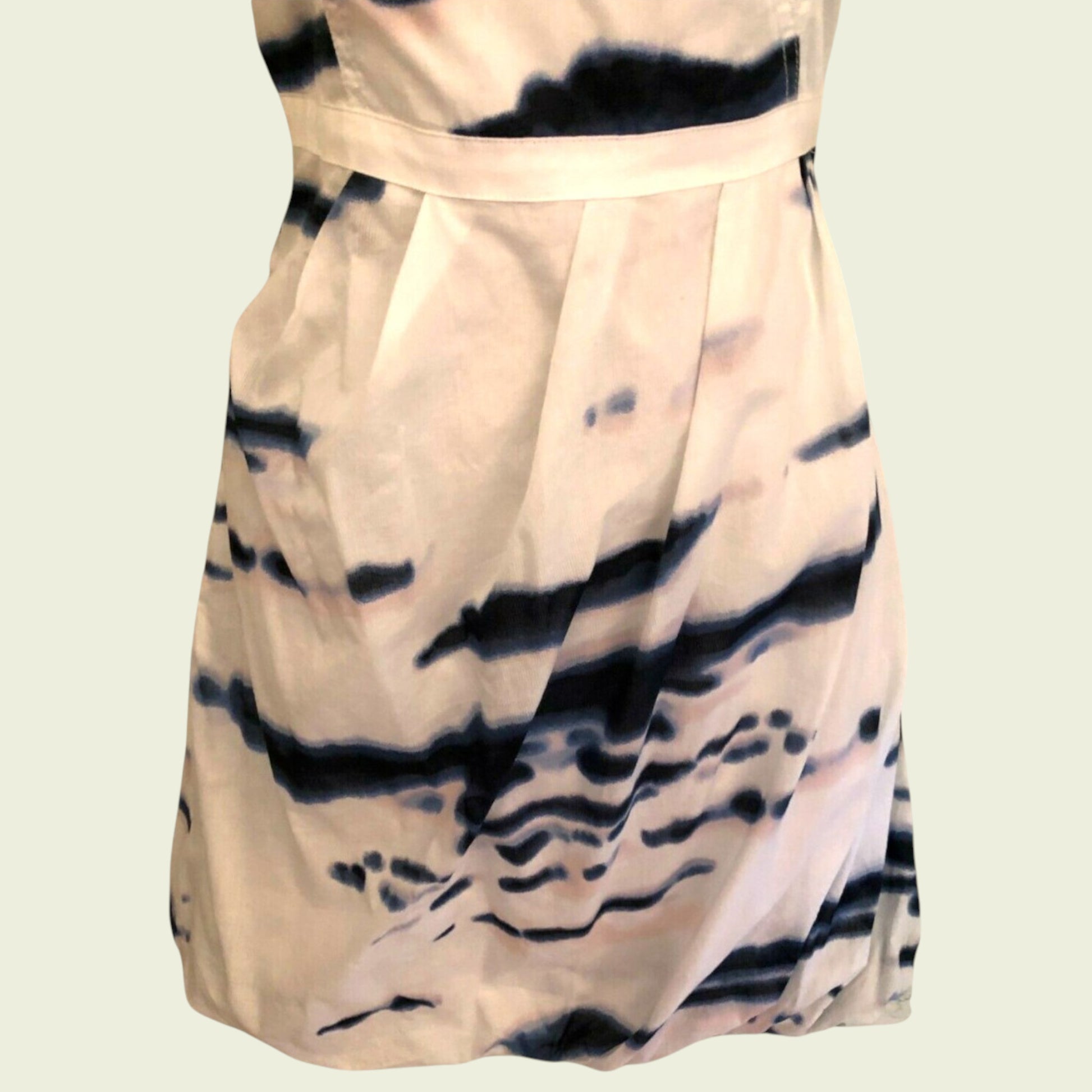 Beige dress with black abstract pattern on a beige background