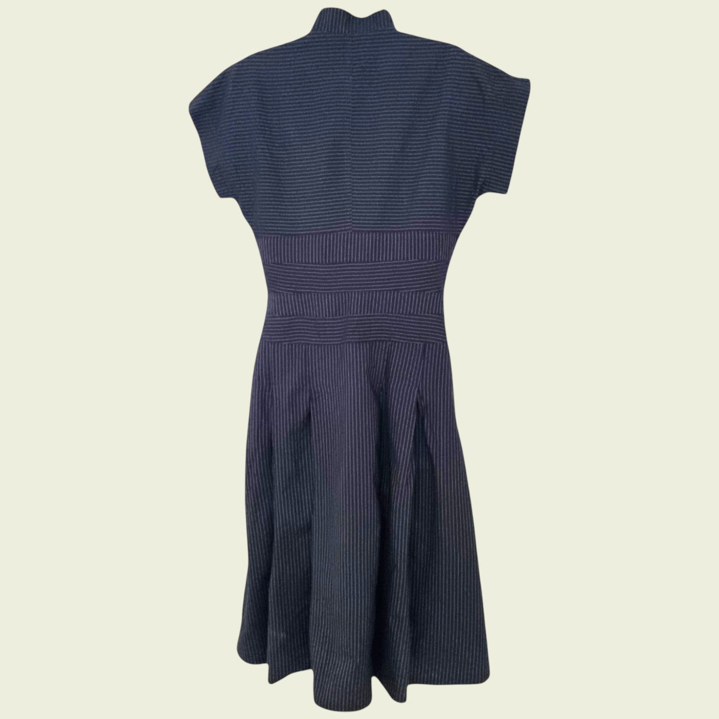 Navy blue dress with a fitted bodice and flared skirt on a beige background