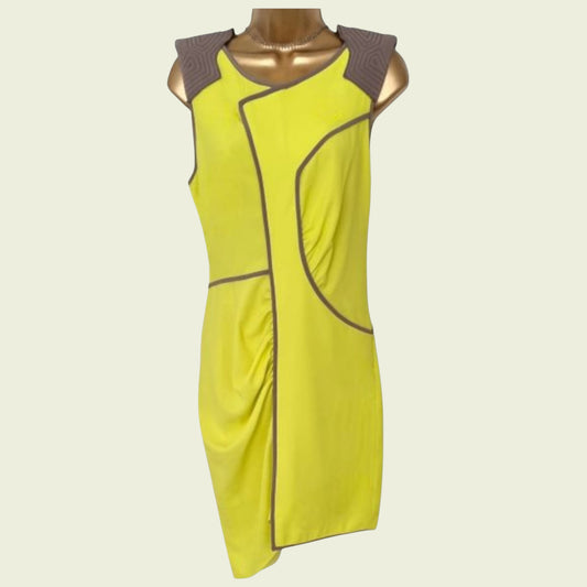 Yellow dress with brown accents on a mannequin against a white background