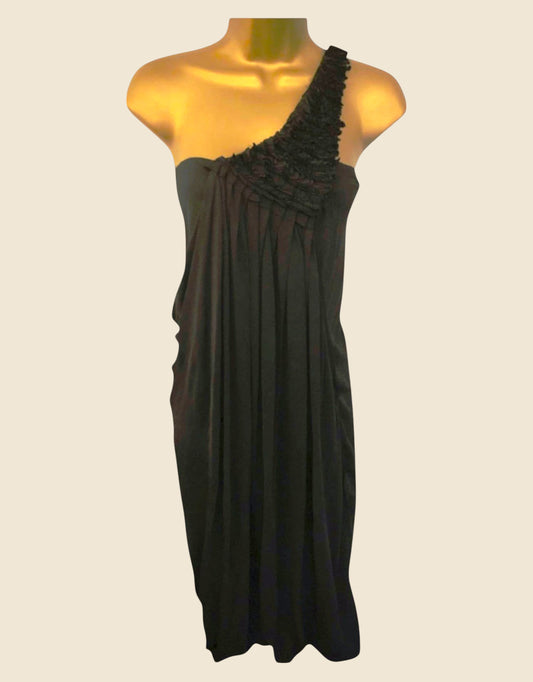 Black one-shoulder dress on a mannequin against a beige background