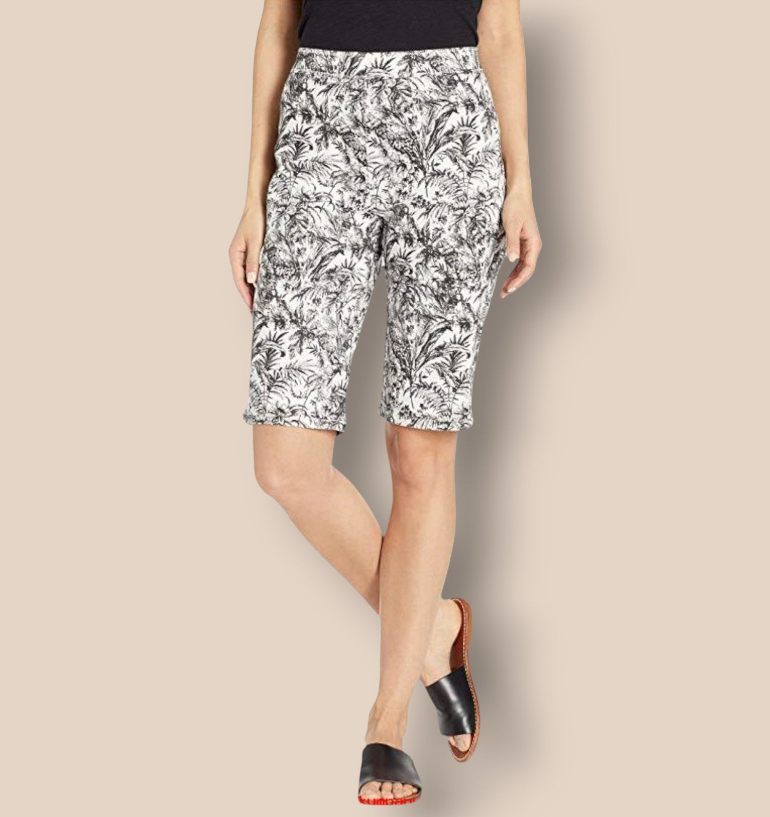 Woman wearing black and white patterned shorts on a beige background