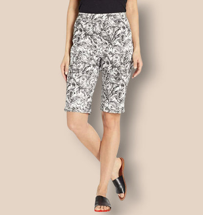 Woman wearing black and white patterned shorts on a beige background