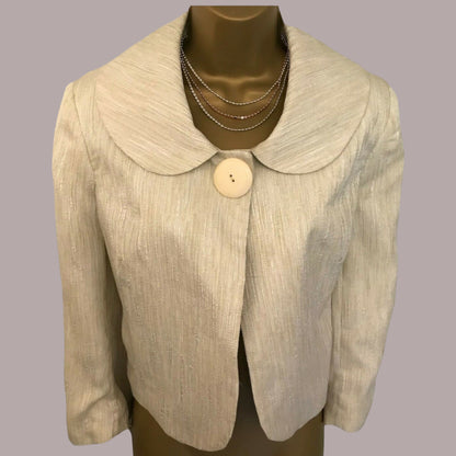 Beige blazer with a large button on a mannequin against a gray background