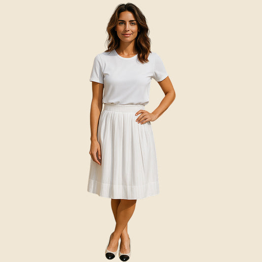 Woman wearing a white t-shirt and cream skirt on a beige background