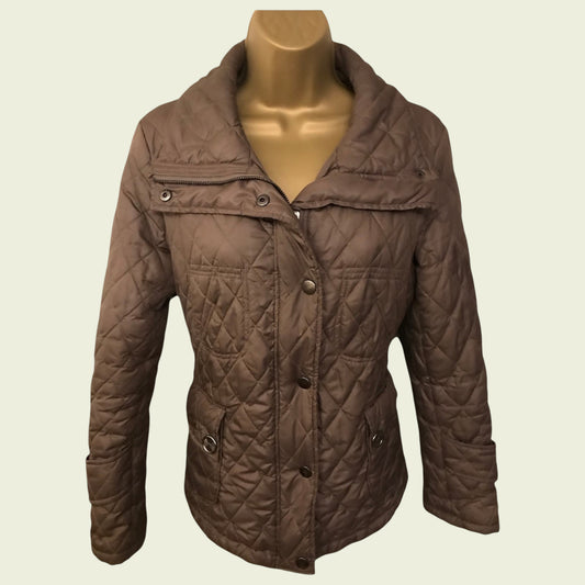 Quilted brown jacket on a mannequin against a beige background