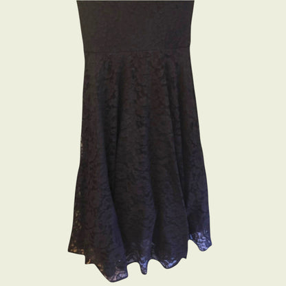 Black lace dress on a beige background