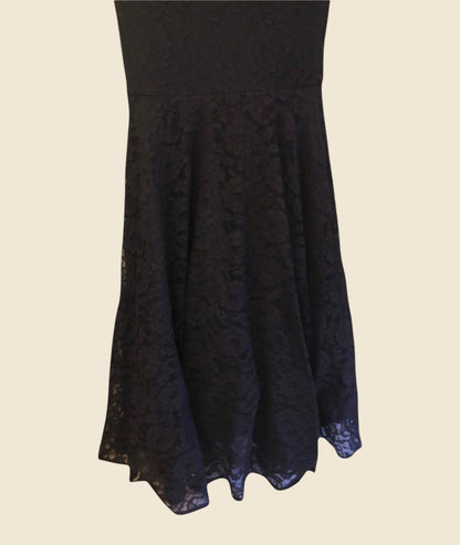 Black lace dress on a beige background